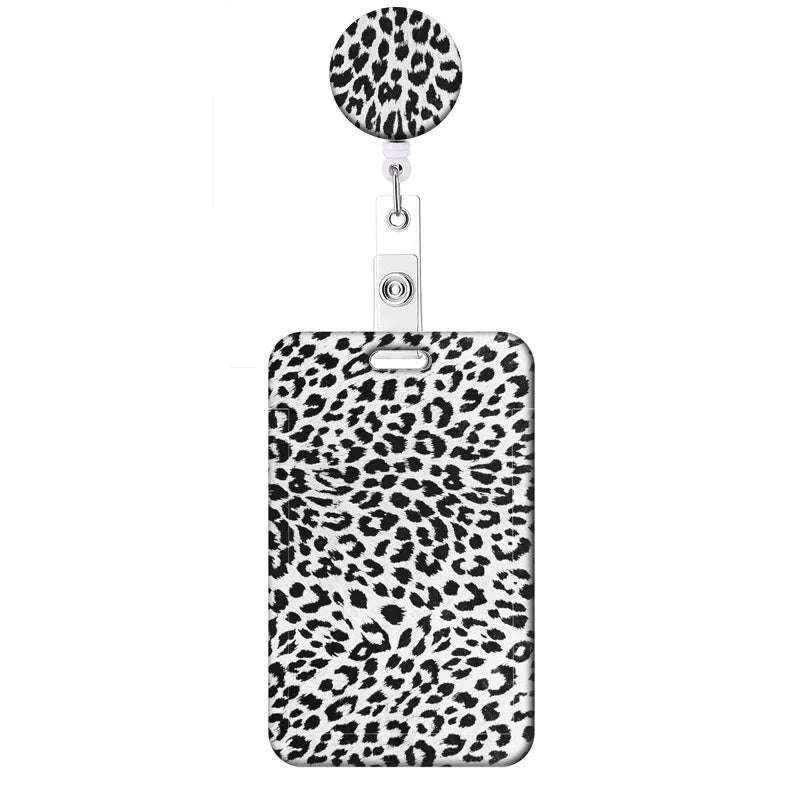 A leopard print retractable badge holder with a circular clip and a rectangular holder.