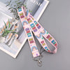 Pink lanyard with rainbow text Be Kind for an autism awareness ID badge holder