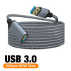 A coiled gray nylon braided USB 3.0 extension cable with a connector visible.