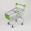 A silver mini shopping cart desktop organizer with green accents and rolling wheels.