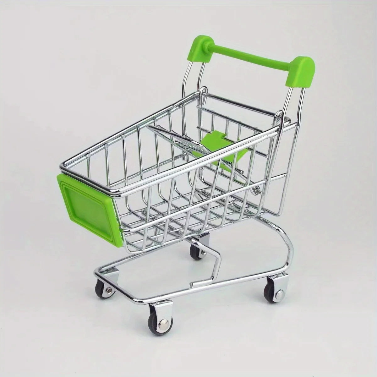A silver mini shopping cart desktop organizer with green accents and rolling wheels.