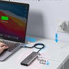 A laptop is connected to a portable 100W max stable cool power adapter for safe operation.