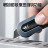 A hand holds a gray mini pocket knife with a black grip, demonstrating its self-sharpening feature.