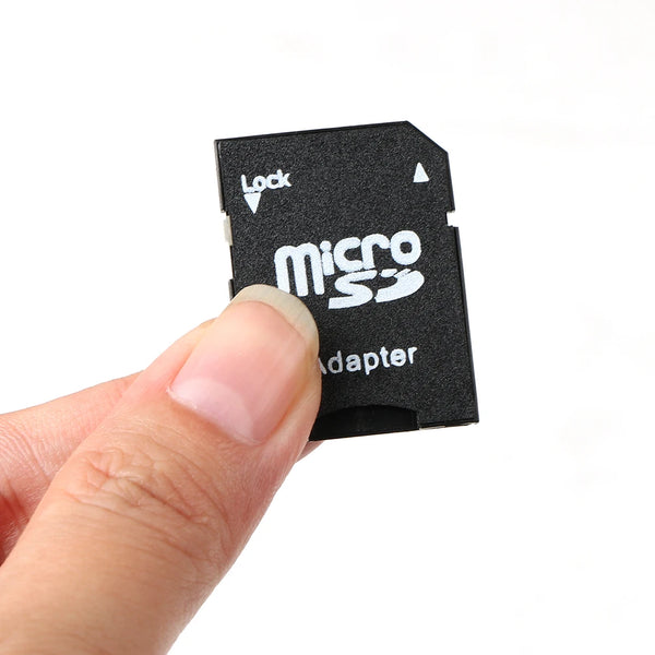 A hand holds a black multi-function memory card adapter with a lock feature.
