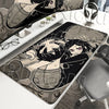 A gaming mouse pad featuring a stylized illustration of a character with dark hair and pink eyes.