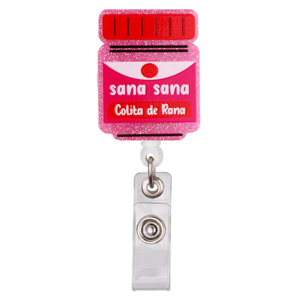 Rosa Glitzer-Acryl-ID-Badge-Klemme mit rotem Augendesign und dem Text Sana Sana Colita de Rana
