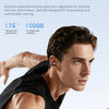 A man is shown exercising while wearing black athletic clothing and an earbud.