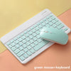 A light green portable Bluetooth keyboard and mouse combo resting on a beige surface.