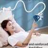 A woman is using a multifunctional mobile phone holder with a flexible gooseneck to hold her phone while resting in bed.