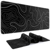A black mouse pad featuring white topographic line patterns, shown flat and folded.