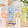 A collection of portable rechargeable mini handheld fans in pink, blue, white, and lime green colors.