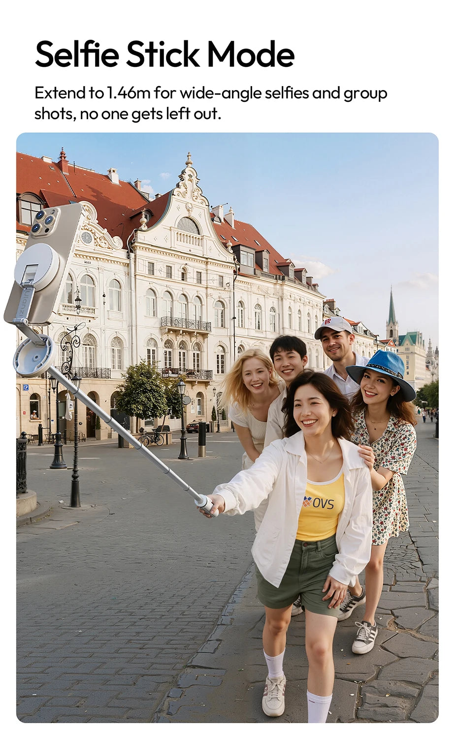 A woman holds a selfie stick extending to 1.46m for group selfies in front of historic European architecture.