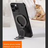 Black double-sided magnetic phone holder with a metal kickstand on a white table.