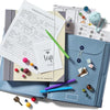 A set of expanding accordion document organizer files showing emergency contacts and other papers with colorful accents