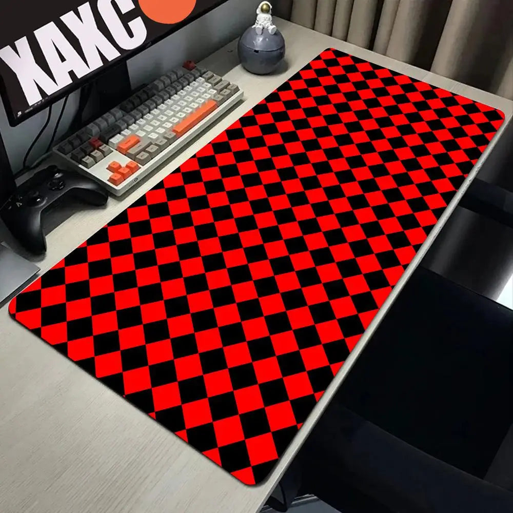 A red and black checkered desk mat is placed on a light-colored desk next to a keyboard and mouse.