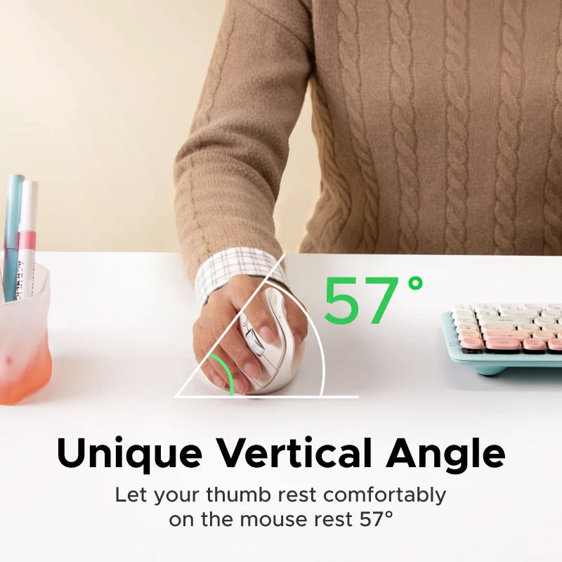 A hand rests on an ergonomic vertical wireless mouse with a 57 degree angle on a white desk.