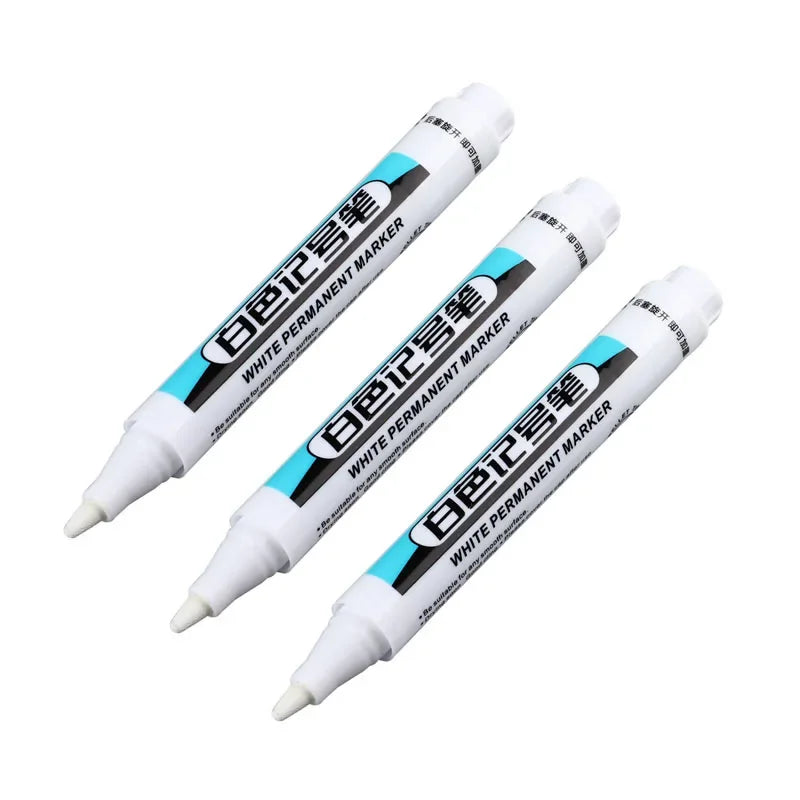 Three white permanent paint marker pens shown diagonally against a white background.
