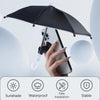 A hand holds a black umbrella stand with a suction cup, designed to hold a smartphone.