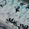 A close-up view of a custom keycap set featuring black and white anime designs on white PBT cherry profile keycaps.