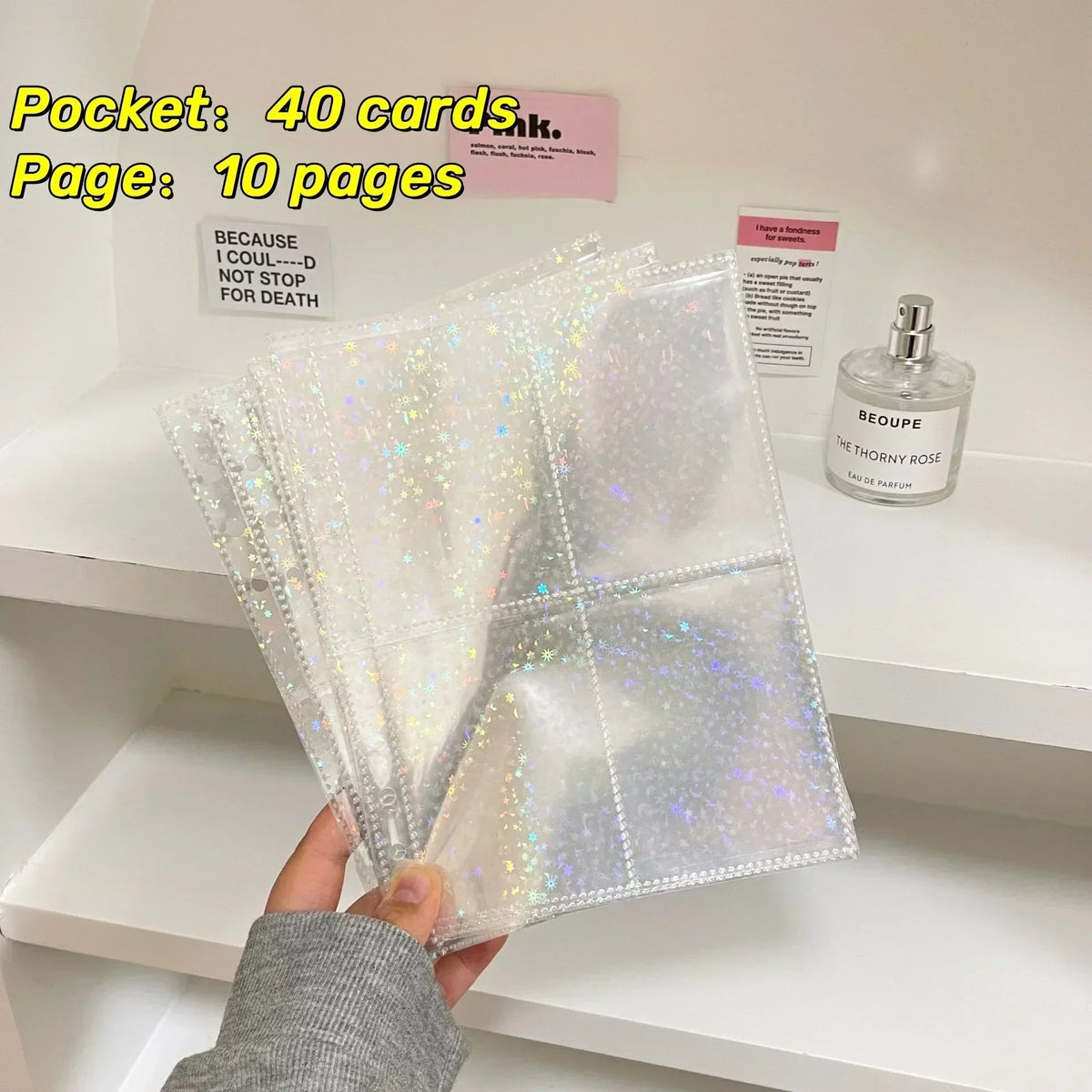 A stack of clear, iridescent photo sleeves is displayed next to a perfume bottle and labeled with card counts.