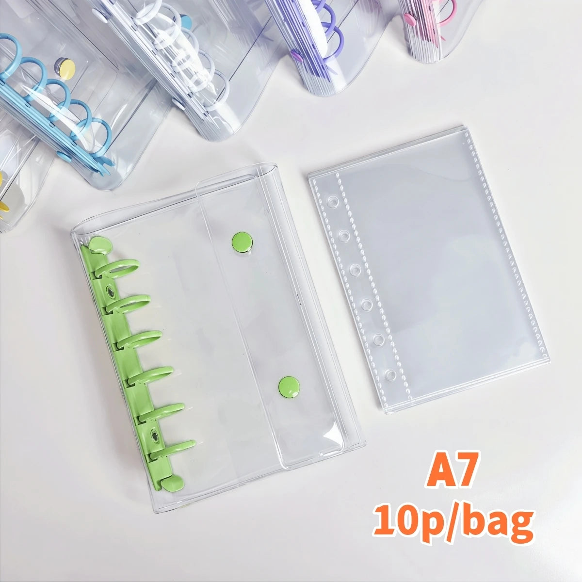 A clear double-button binder for stickers and journaling with green and purple accessories.
