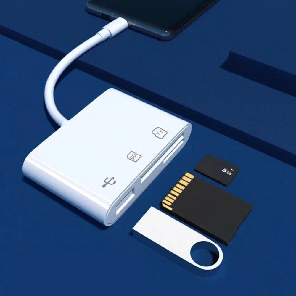 A white 3-in-1 multi-format memory card reader and adapter connected by a white cable, resting on a dark blue surface.