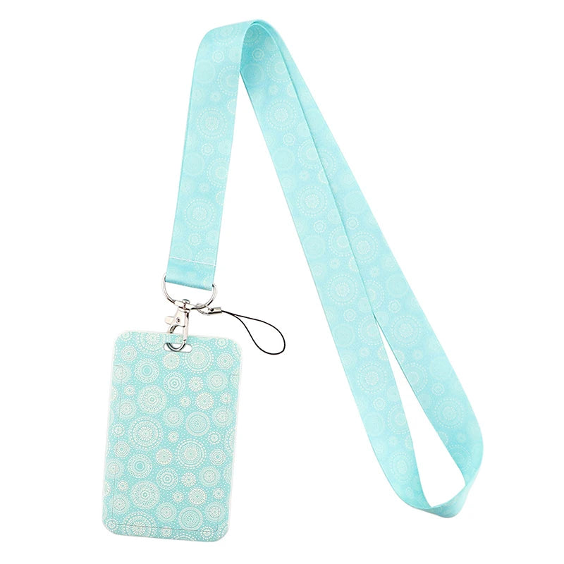 Light blue patterned fabric lanyard with a rectangular tag and a clip.