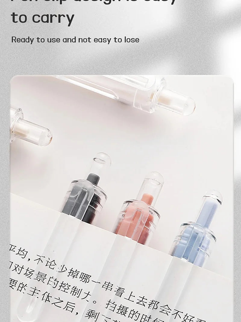 A close-up view of five smooth writing gel pens with black ink, showing various colors and tips.