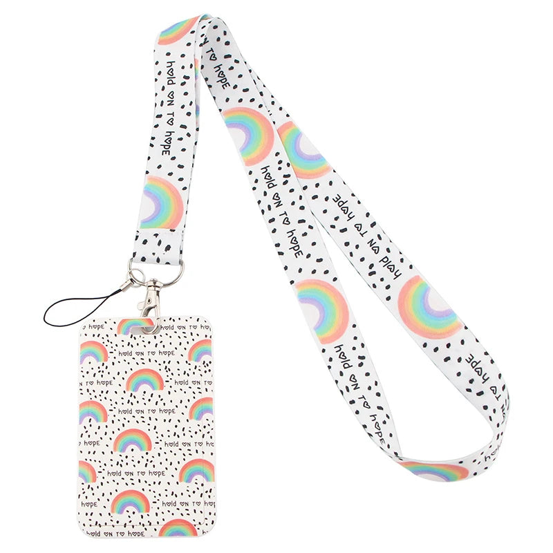 A white minimalist key lanyard featuring a repeating pattern of hopeful text and colorful rainbow stripes.