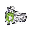 A green frog enamel pin featuring text that reads You Lost Your Focus
