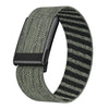 A close-up of a black nylon braided strap for a fitness watch, featuring a gray and black striped pattern.