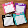 A pack of four retro floppy disk sticky notes with a cosmic moon theme in pink, purple, and teal colors.