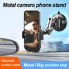 Metal camera phone stand mounted on a car windshield, showing an adjustable angle for photography.