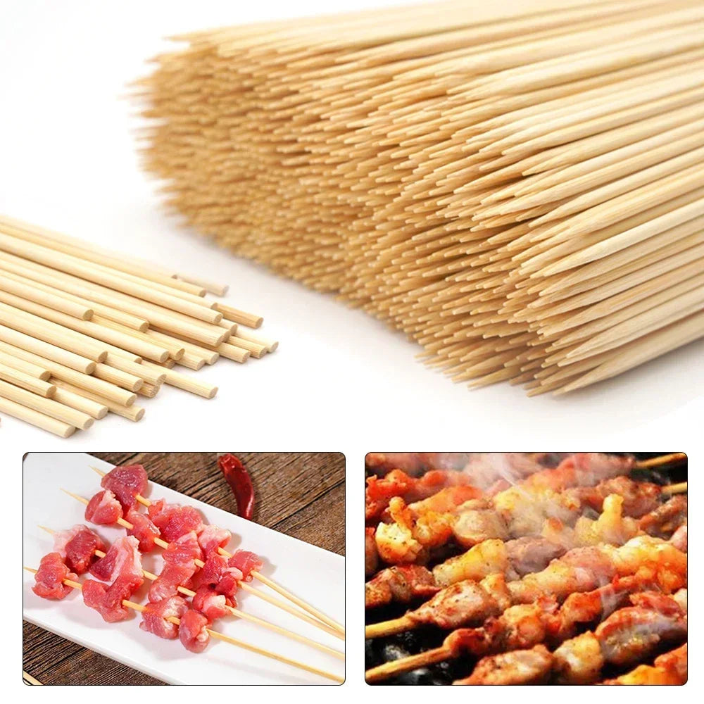A large bundle of natural bamboo skewers and a plate of cooked meat on skewers.