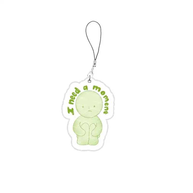 A clear acrylic charm shaped like a sad, pale green face attached to a silver chain.