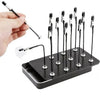 A hand holds a magnetic painting stand with multiple vertical holders for art and craft supplies.