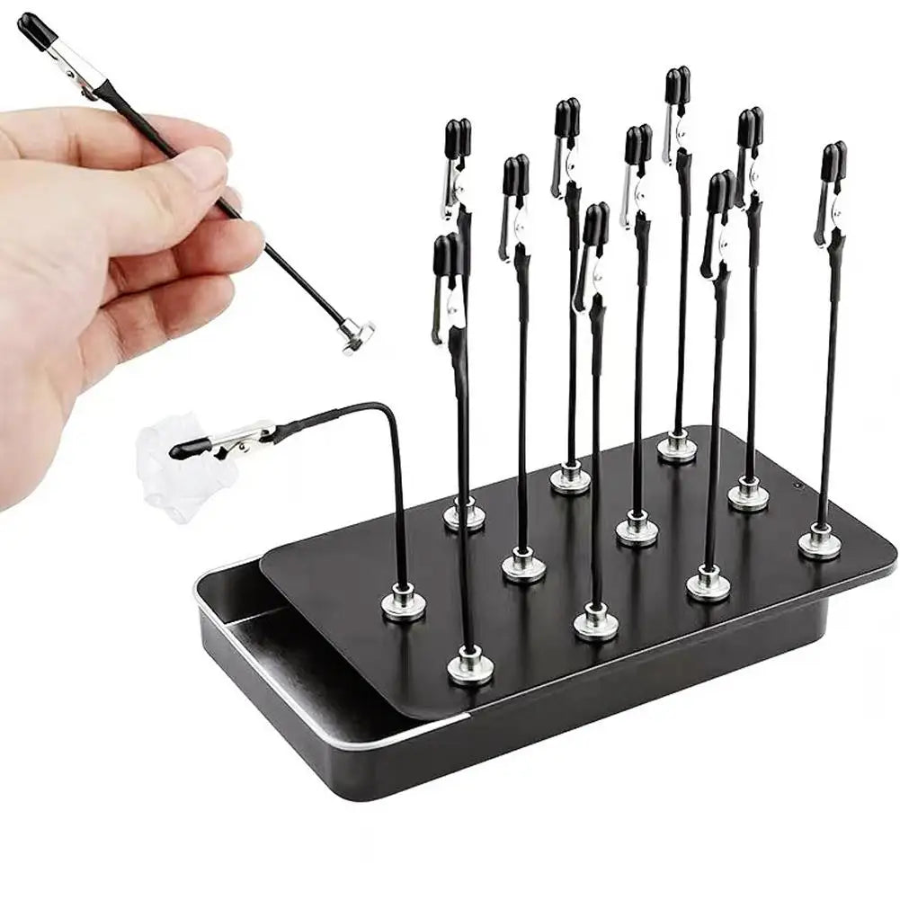 A hand holds a magnetic painting stand with multiple vertical holders for art and craft supplies.