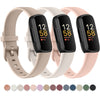 Three silicone replacement straps in beige, white, and pink for a Fitbit Inspire Series watch.