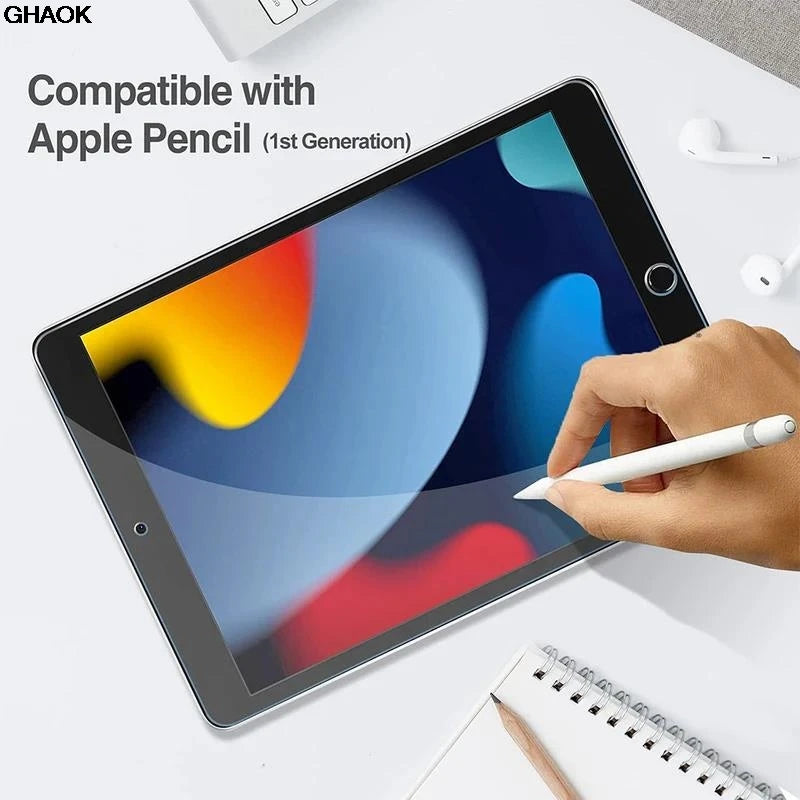 A hand holds a white stylus on an iPad screen with a tempered glass protector installed.