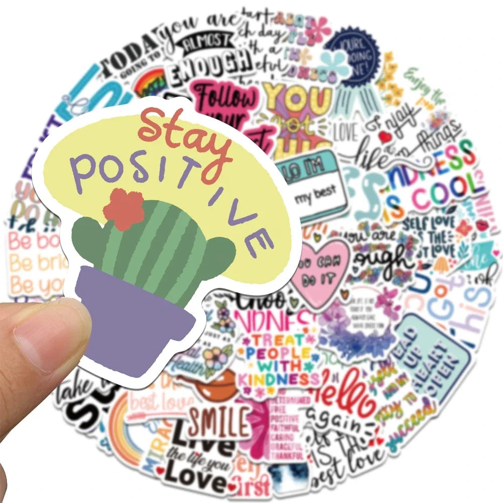 A hand holds up an inspirational quote sticker pack featuring the text Stay Positive surrounded by colorful positive affirmat