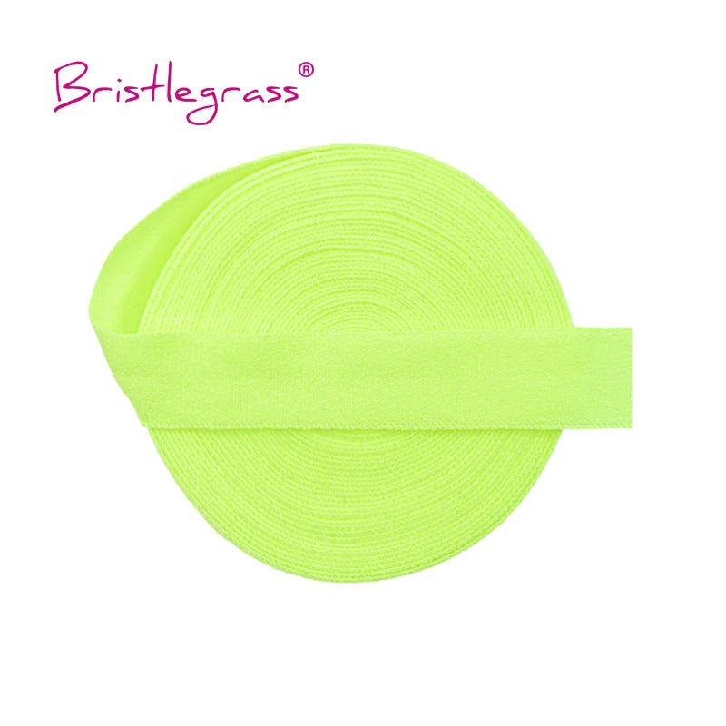 A bright lime green elastic hair tie or trim rolled into a circular shape.