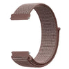 A close-up view of a rose gold nylon loop watch strap with a textured weave and a rectangular buckle.