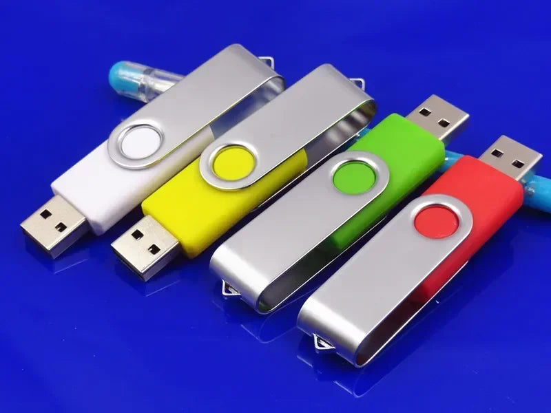 A collection of colorful metal USB 2.0 flash drives displayed on a blue surface.