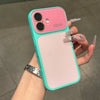 A hand holds a pink and teal color block phone case with full lens protection and a silver bracelet.