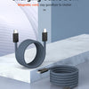 A coiled magnetic charging cable with USB-C connectors is displayed on a white marble surface.