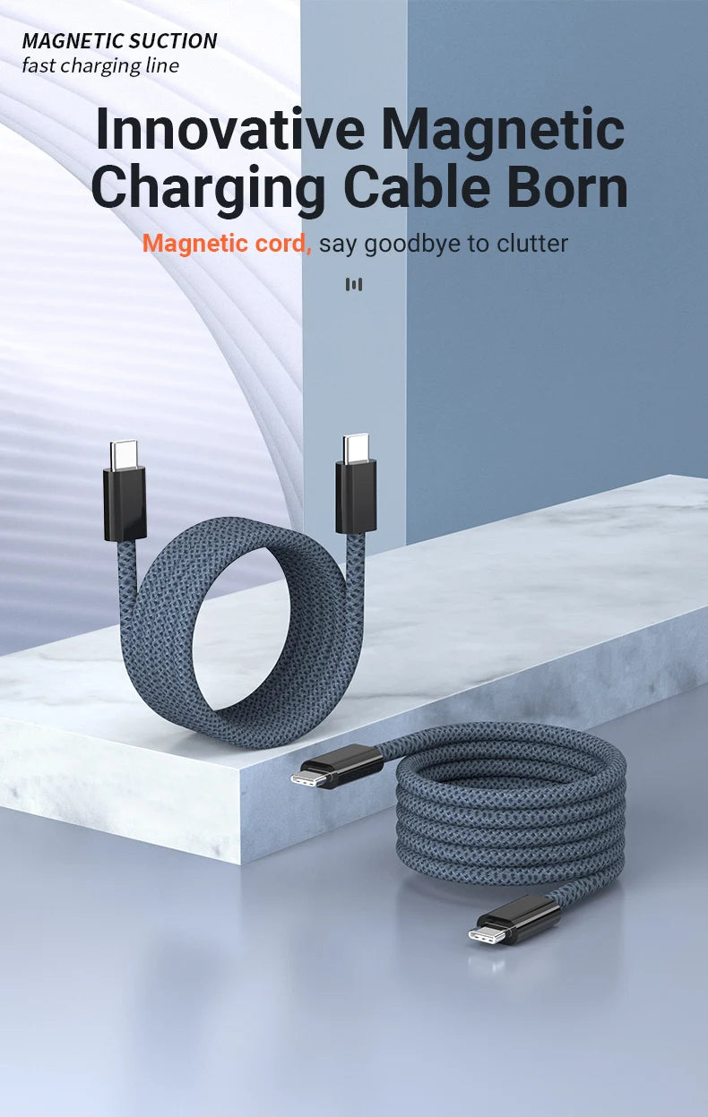 A coiled magnetic charging cable with USB-C connectors is displayed on a white marble surface.