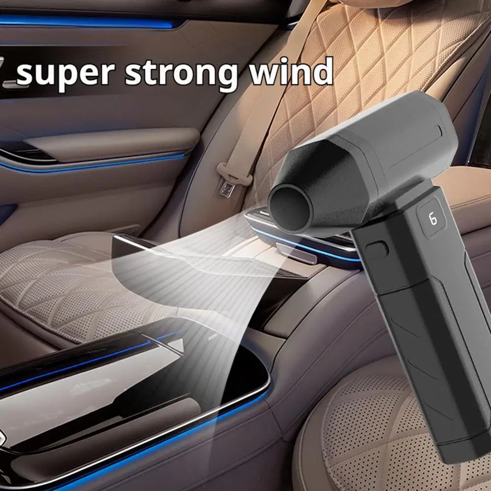 A handheld air blower is shown blowing a strong stream of air onto a car interior surface.
