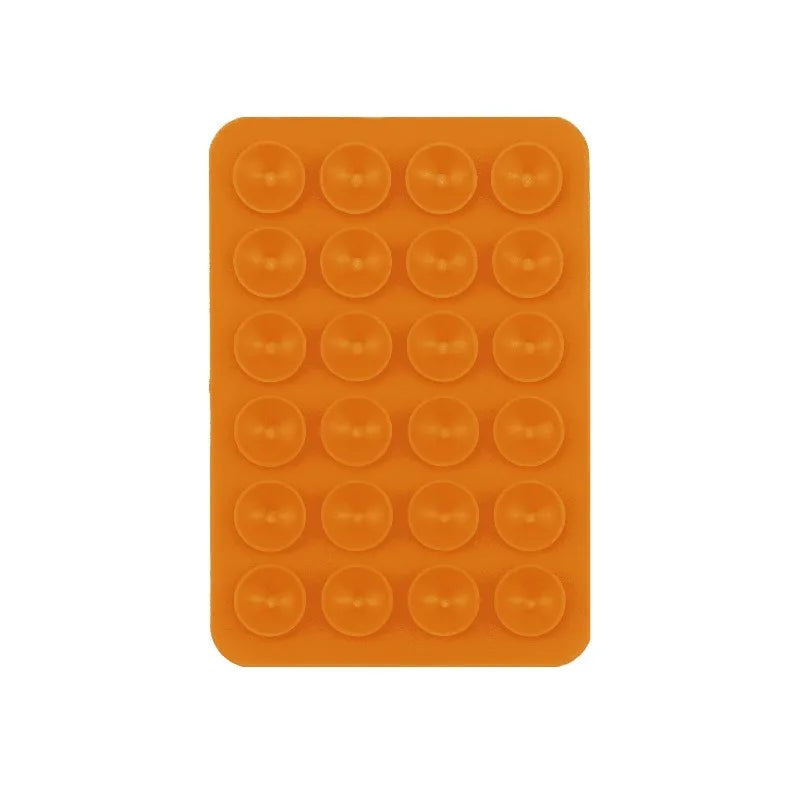 A rectangular orange silicone suction cup mount product with multiple circular cups.