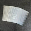 A fan of clear protective sleeves for trading cards, showing a stack of translucent plastic sleeves.