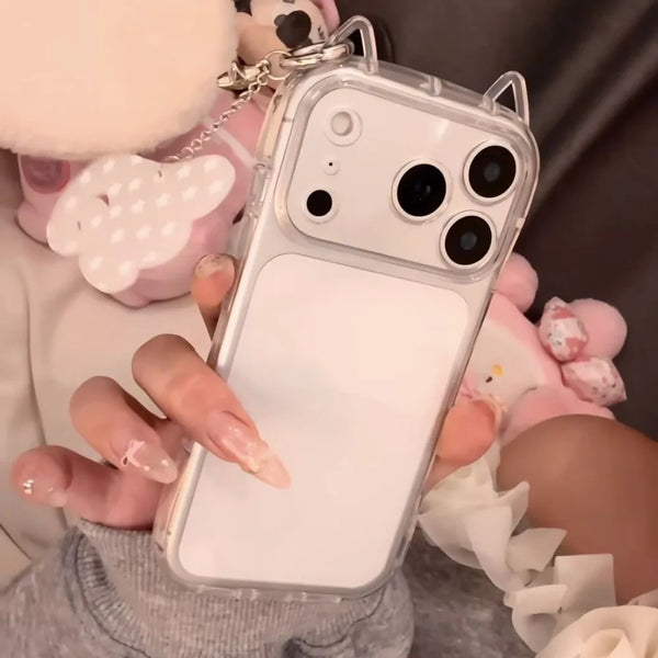 A hand holds a white iPhone in a clear case with cat ears, demonstrating shockproof protection.
